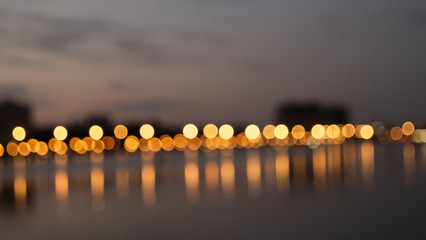 Bokeh night lights blurry abstract backgroun og city waterfront in a night - obrazy, fototapety, plakaty