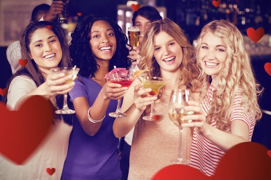 Composite image of friends drinking cocktails together