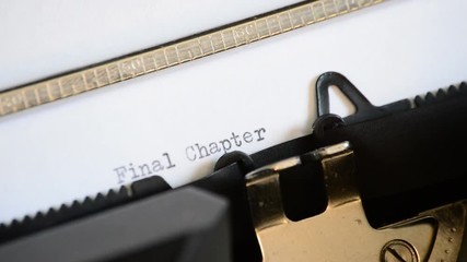 Typing the expression Final Chapter with an old manual typewriter