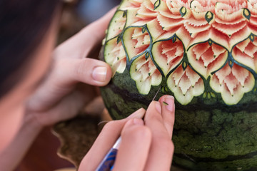 lady's hand crafting watermelon in a floral pattern