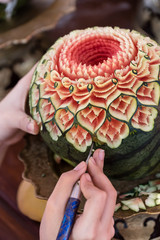 lady's hand crafting watermelon in a floral pattern