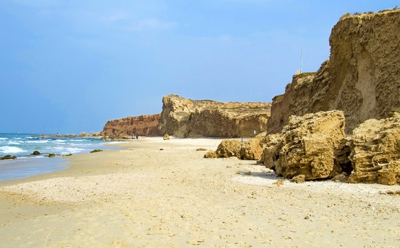 The beautiful sandy beach with cliffs