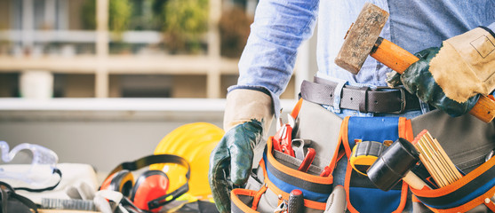 Worker with a tool belt and a hammer
