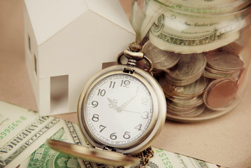 Money saving concept with vintage clock for the past.