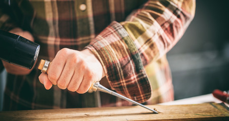 Carpenter working with a chisel