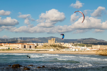 Man practicing kitesurfing on the beach of Tarifa, Spain. Tarifa is considered the capital of the...