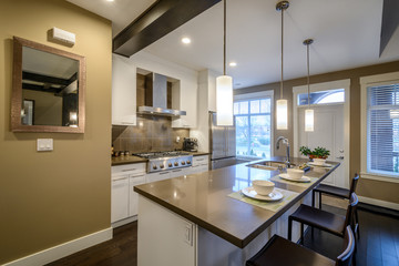 Modern, bright, kitchen with an island in a luxury house. Interior design.