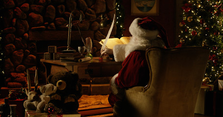 Santa Claus uses a massive quill pen to double-check his naughty list.