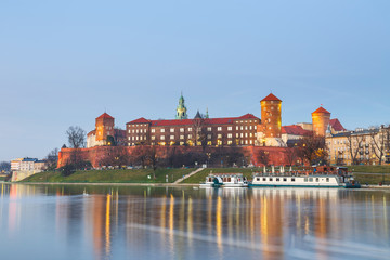 Naklejka na ściany i meble Wawel Castle in the evening in Krakow with reflection in the river, Poland. Long time exposure