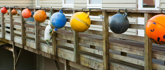 Colored fishing floats hung on pier © kbarrowood