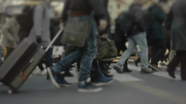 Big city crowd,anonymous people cross busy street slow motion 100p.Gimbal stabilized dolly shot of an anonymous crowd of pedestrians walking/crossing a busy city intersection.No logos or faces visible