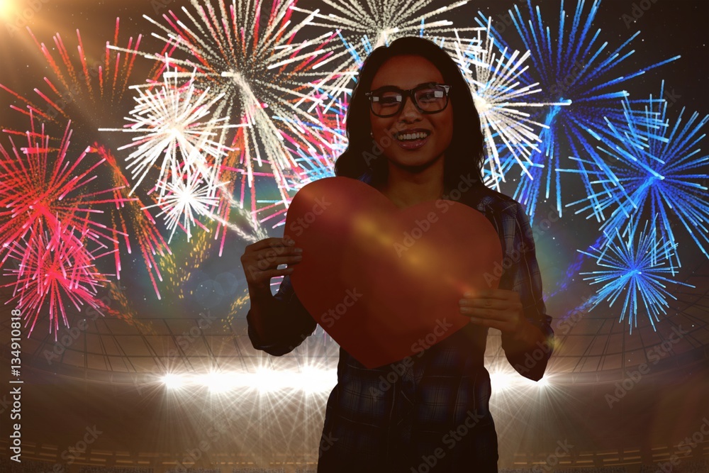 Wall mural Composite image of asian woman holding paper heart