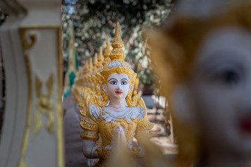 The plaster statue on the temple fence.