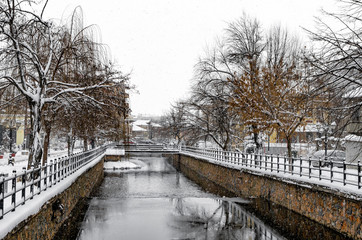 Naklejka na ściany i meble Picturesque winter scene by the river of Florina, a small town in northern Greece 