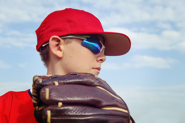 Closeup of a boy pitcher, focus on side of boys face.