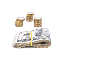 a bundle of money and stacks of coins 