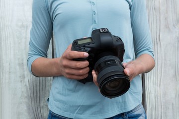 Mid section of female photographer 