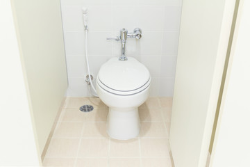 White water closet and tile floor in toilet room.
