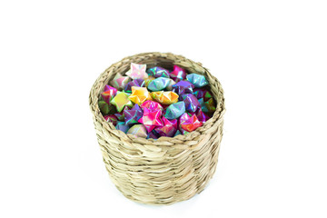 Fototapeta na wymiar colorful of paper fold christmas stars in the wood basket