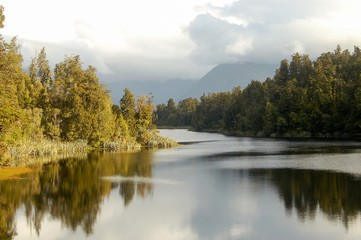 Fototapeta na wymiar Clouds over Lake Matheson in the Glaciers Country on the South Island of New Zealand