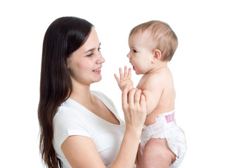 Portrait of young woman looking at her baby daughter. Mother playing with kid.