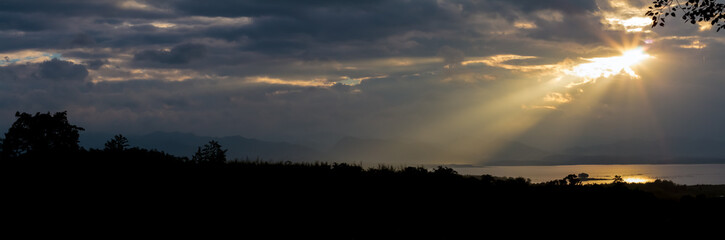 Sun rays during sunrise over the moutain