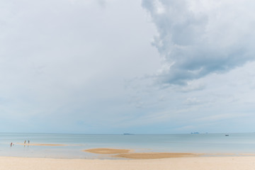 Fototapeta na wymiar Cloudy sky with sea and sand