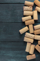 Wine corks on dark wooden texture with copyspace
