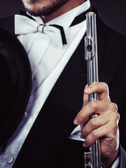 Obraz premium Elegantly dressed musician holding flute