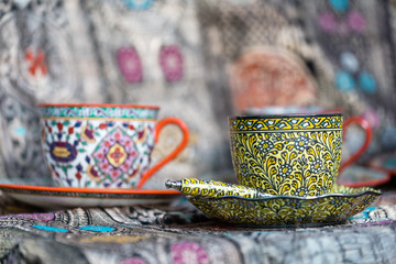 vintage tea cup painted in colorful floral pattern