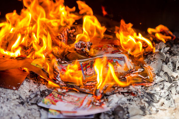 Joss paper burning in flame during Chinese New Year