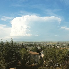 Large summer storm cloud over city