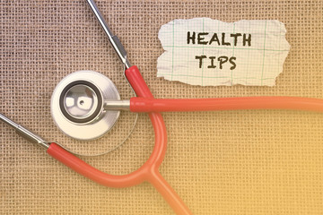 Stethoscope, paper with word “ HEALTH .TIPS “. Medical Concept