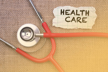 Stethoscope and paper with word Health Care. Medical Concept