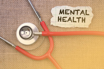Stethoscope, paper with word “ MENTAL.HEALTH “. Medical Concept