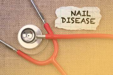 Stethoscope, paper with word “ NAIL DISEASE “. Medical Concept