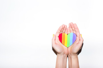 Rainbow painted heart in open palms