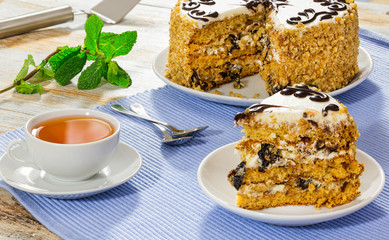portion of sponge prune cake decorated with shiny chocolate glaz