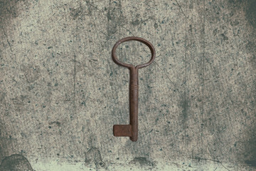 Old key on the old textured paper with natural patterns