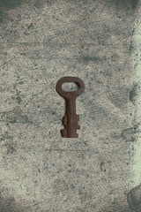 Old key on the old textured paper with natural patterns