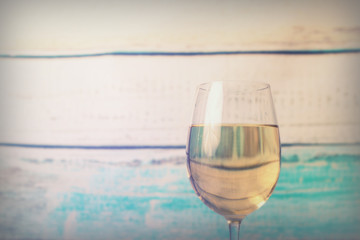 Glass of white wine being poured from bottle