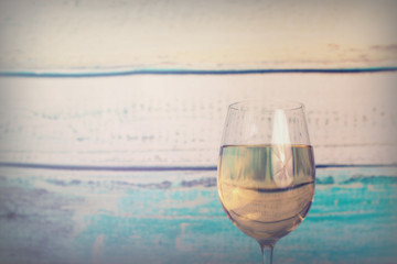 Glass of white wine being poured from bottle