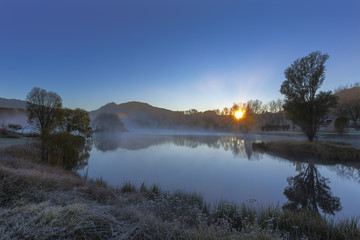Fototapeta na wymiar Sunrise with mist on the water