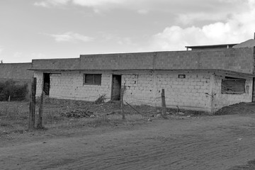 Quiet dirt road in rural farming village with concrete buildings in Puebla not far from Pico de Orizaba volcano, Mexico