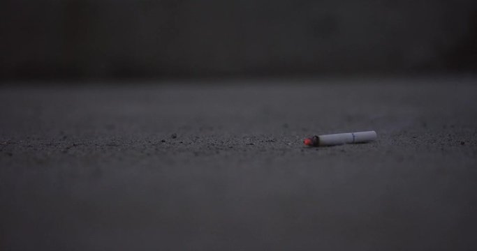 Cigarette falls to pavement