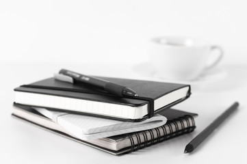 Stack of notepads and coffee