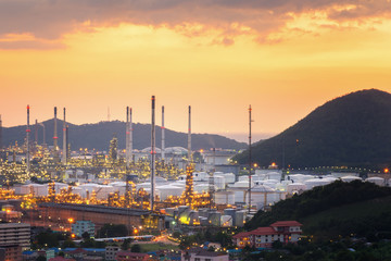 Fototapeta premium Aerial view oil refinery night with mountain background during twilight,Industrial zone,Energy power station.