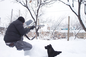 Fototapeta na wymiar Hunter with a gun. Hunting in the winter.