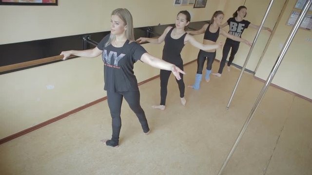 Beautiful young girl doing workout in dance studio stock footage video