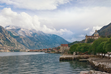 Fototapeta na wymiar View of Bay of Kotor and seaside Prcanj town on a cloudy winter day. Montenegro
